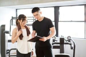 Asian male personal trainer counseling on periodization
