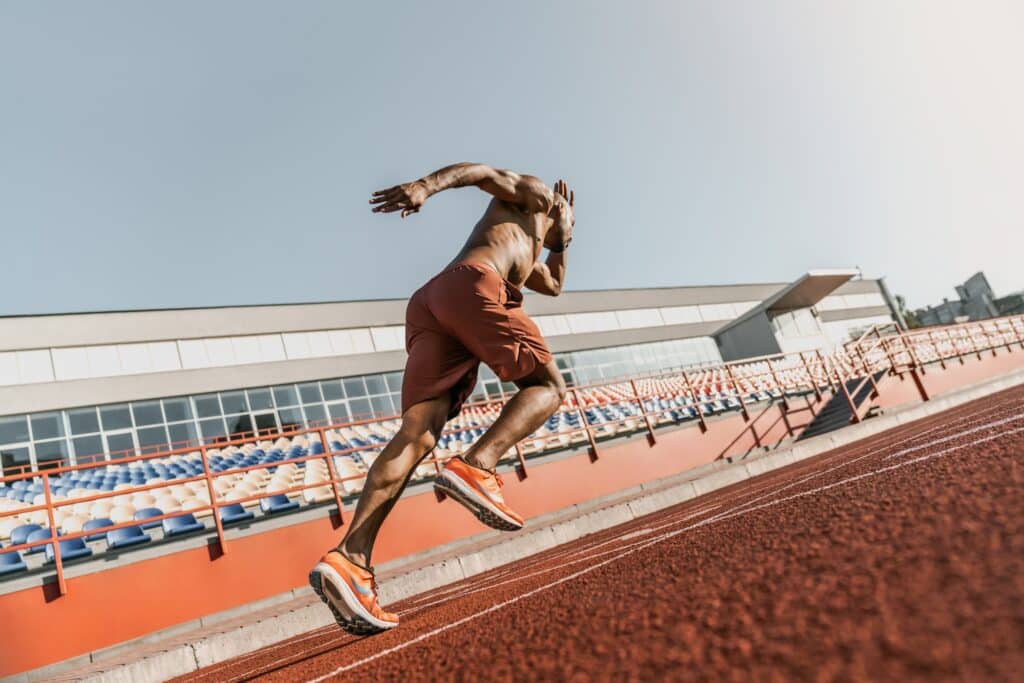 Rear view of an athlete starting his sprint on an all-weather running track nsca cscs exam